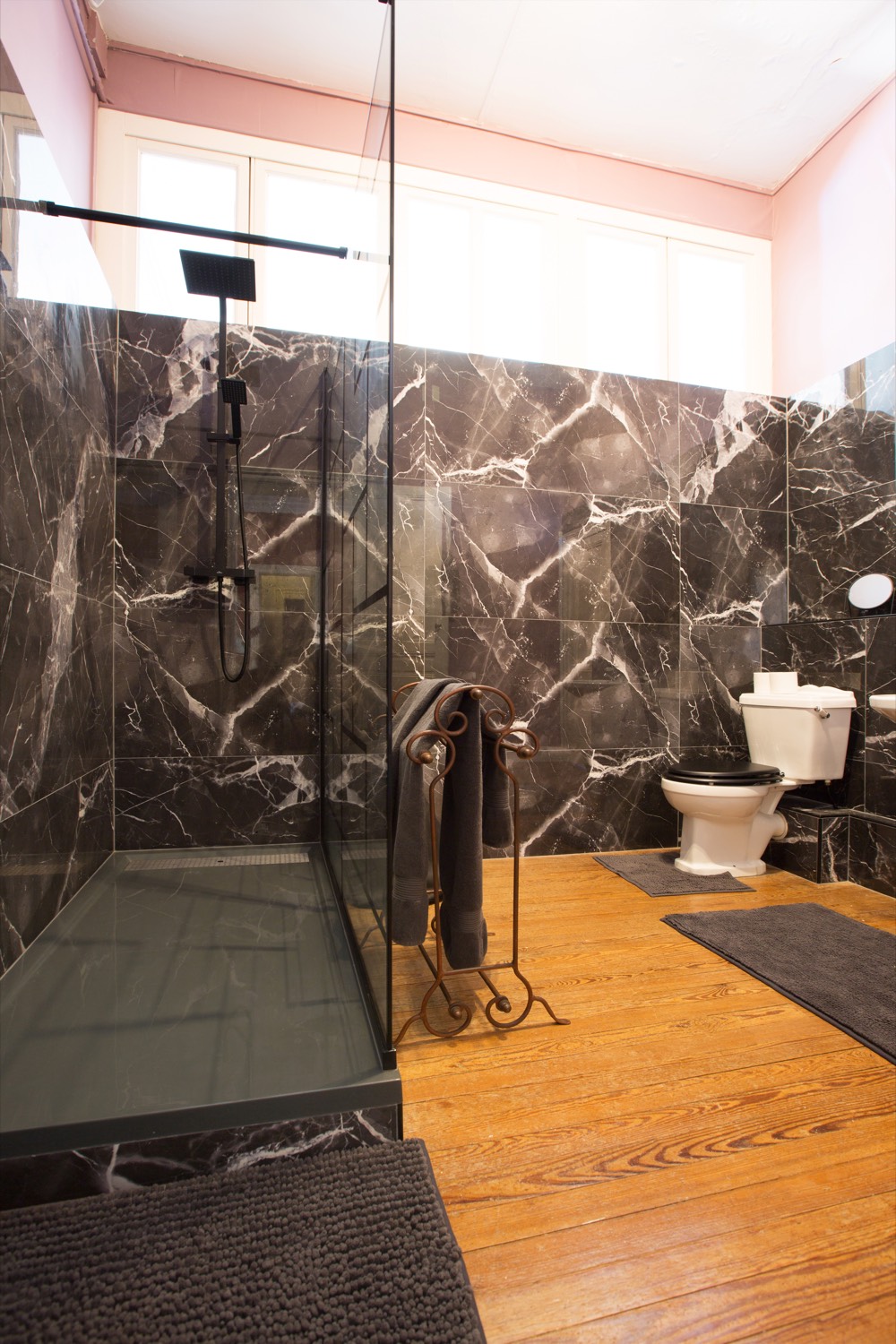 Bathroom with black marble walls and a large walk-in shower